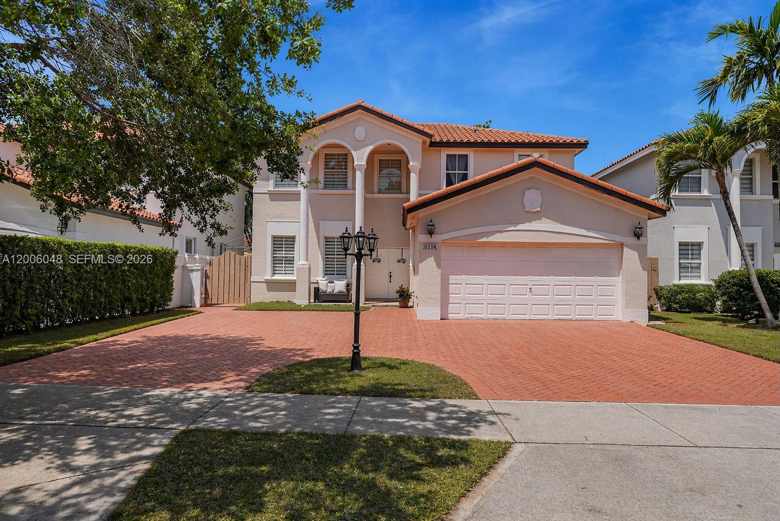 6114 Southwest 158th Pass Miami, FL 33193 - Photo 1 of 37 a front view of a house with a yard