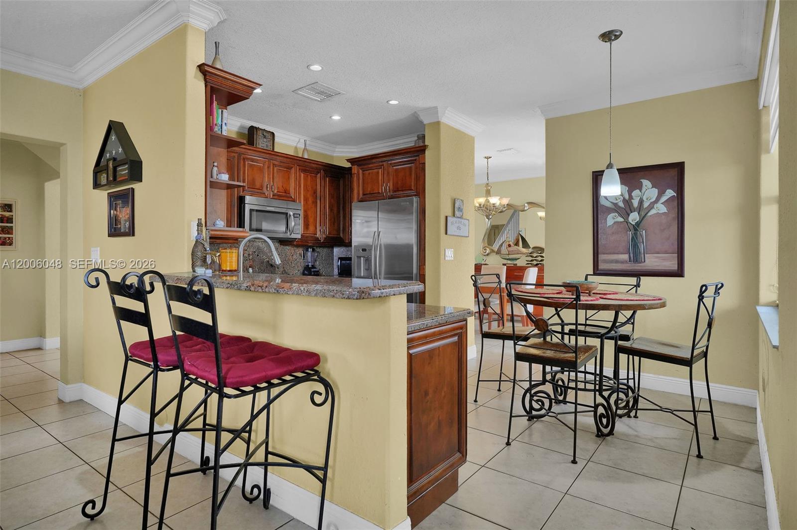 6114 Southwest 158th Pass Miami, FL 33193 - Photo 11 of 37 a dining room with furniture and a chandelier