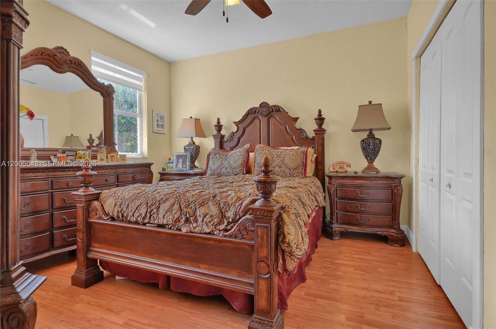 6114 Southwest 158th Pass Miami, FL 33193 - Photo 20 of 37 a bedroom with a bed and a chandelier
