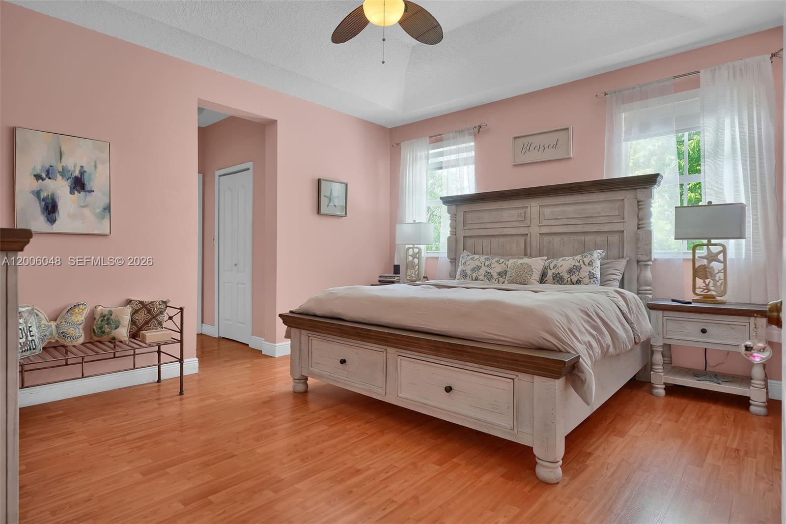 6114 Southwest 158th Pass Miami, FL 33193 - Photo 21 of 37 a bedroom with a bed and a chandelier