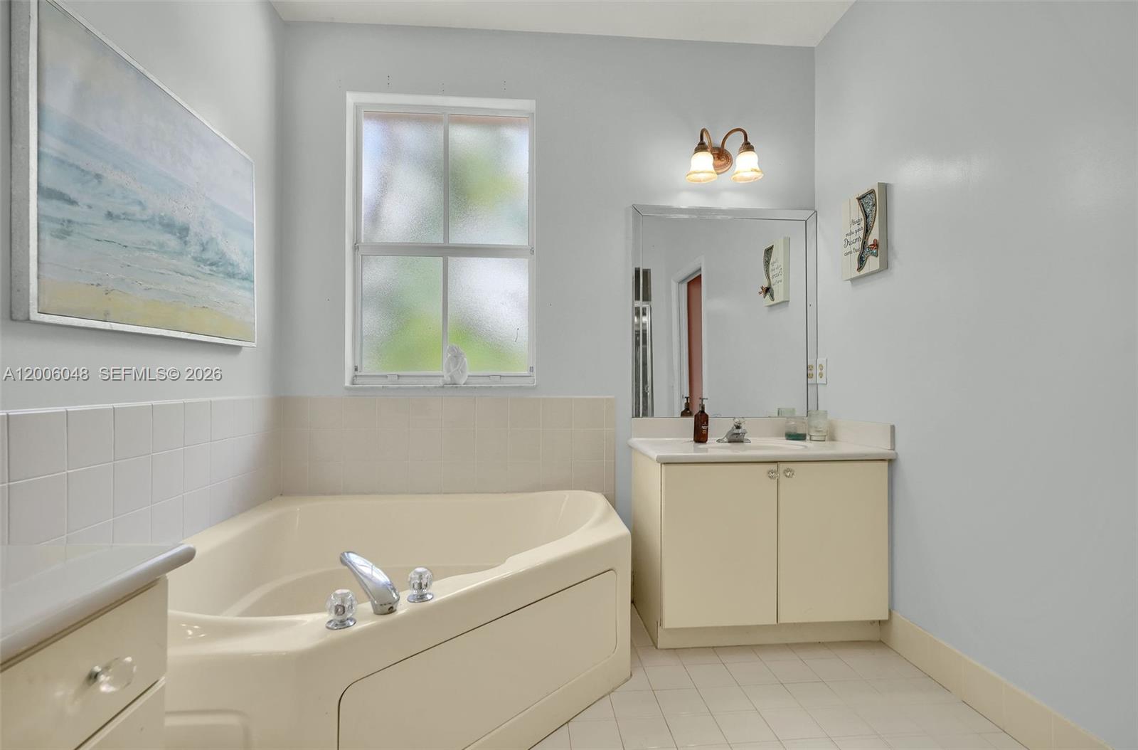 6114 Southwest 158th Pass Miami, FL 33193 - Photo 24 of 37 a bathroom with a tub sink and mirror