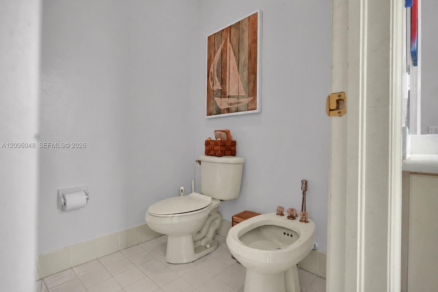 6114 Southwest 158th Pass Miami, FL 33193 - Photo 26 of 37 a white toilet sitting next to a bathroom sink