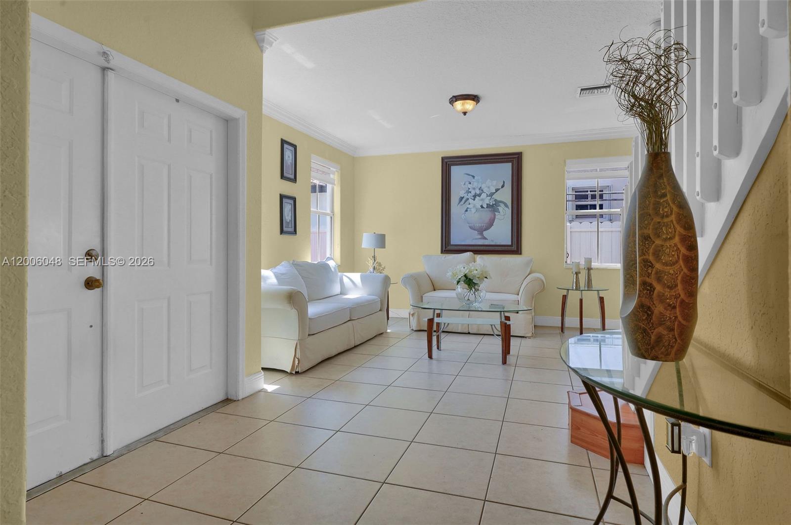 6114 Southwest 158th Pass Miami, FL 33193 - Photo 3 of 37 a living room with furniture a table and a potted plant