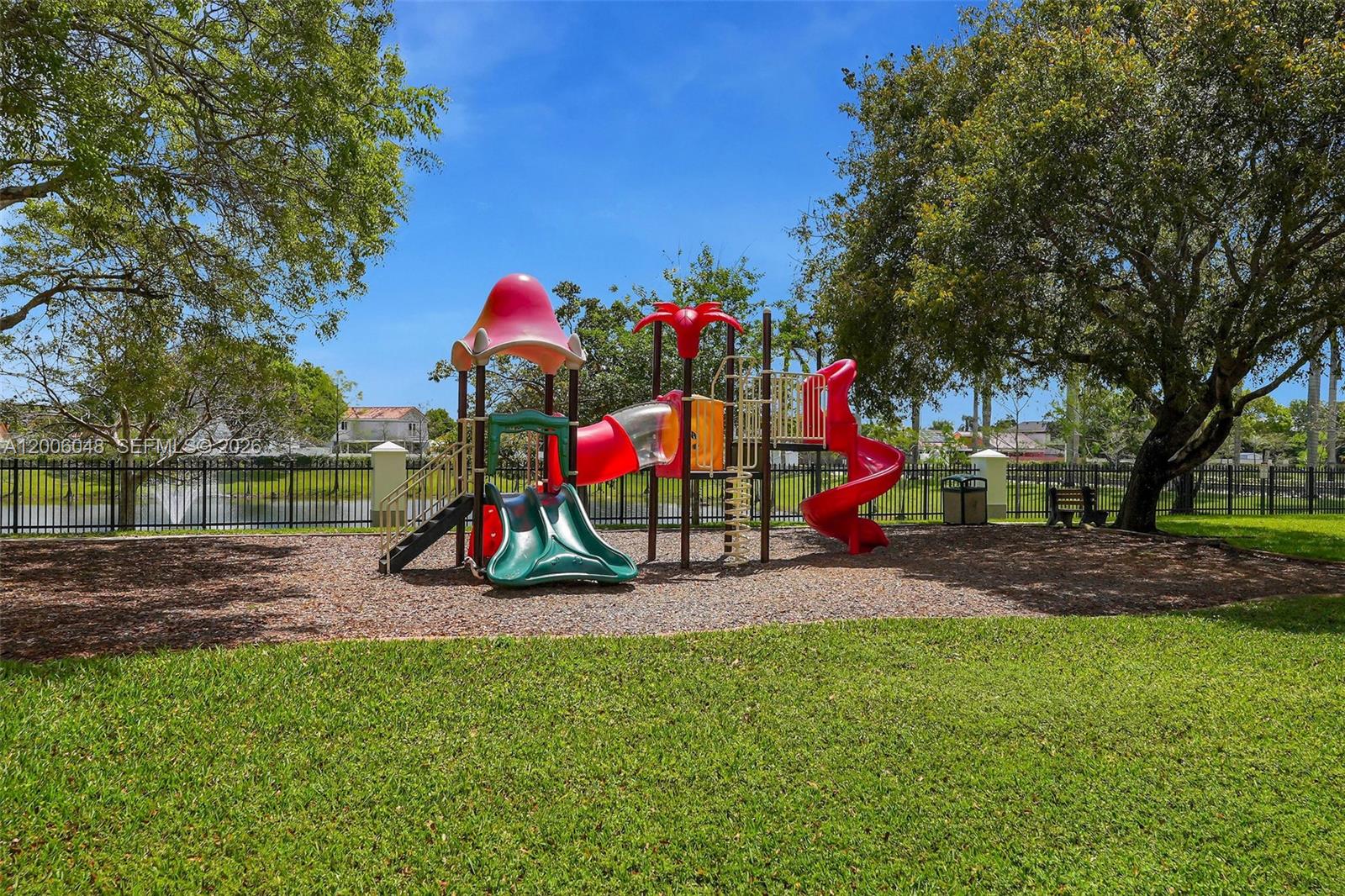 6114 Southwest 158th Pass Miami, FL 33193 - Photo 36 of 37 a view of park with swings and slides