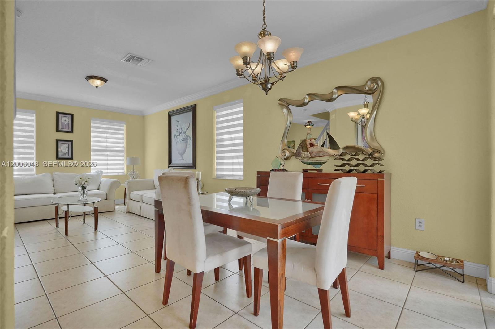6114 Southwest 158th Pass Miami, FL 33193 - Photo 7 of 37 a view of a dining room with furniture and chandelier