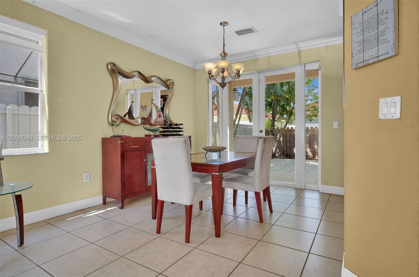 6114 Southwest 158th Pass Miami, FL 33193 - Photo 8 of 37 a view of a dining room with furniture and chandelier