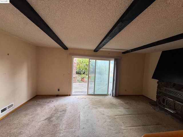 a view of a livingroom with furniture and a fireplace