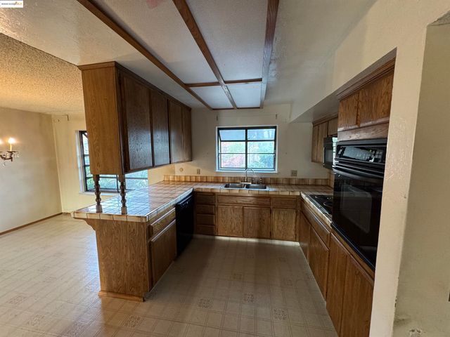 a kitchen with stainless steel appliances granite countertop a sink and stove