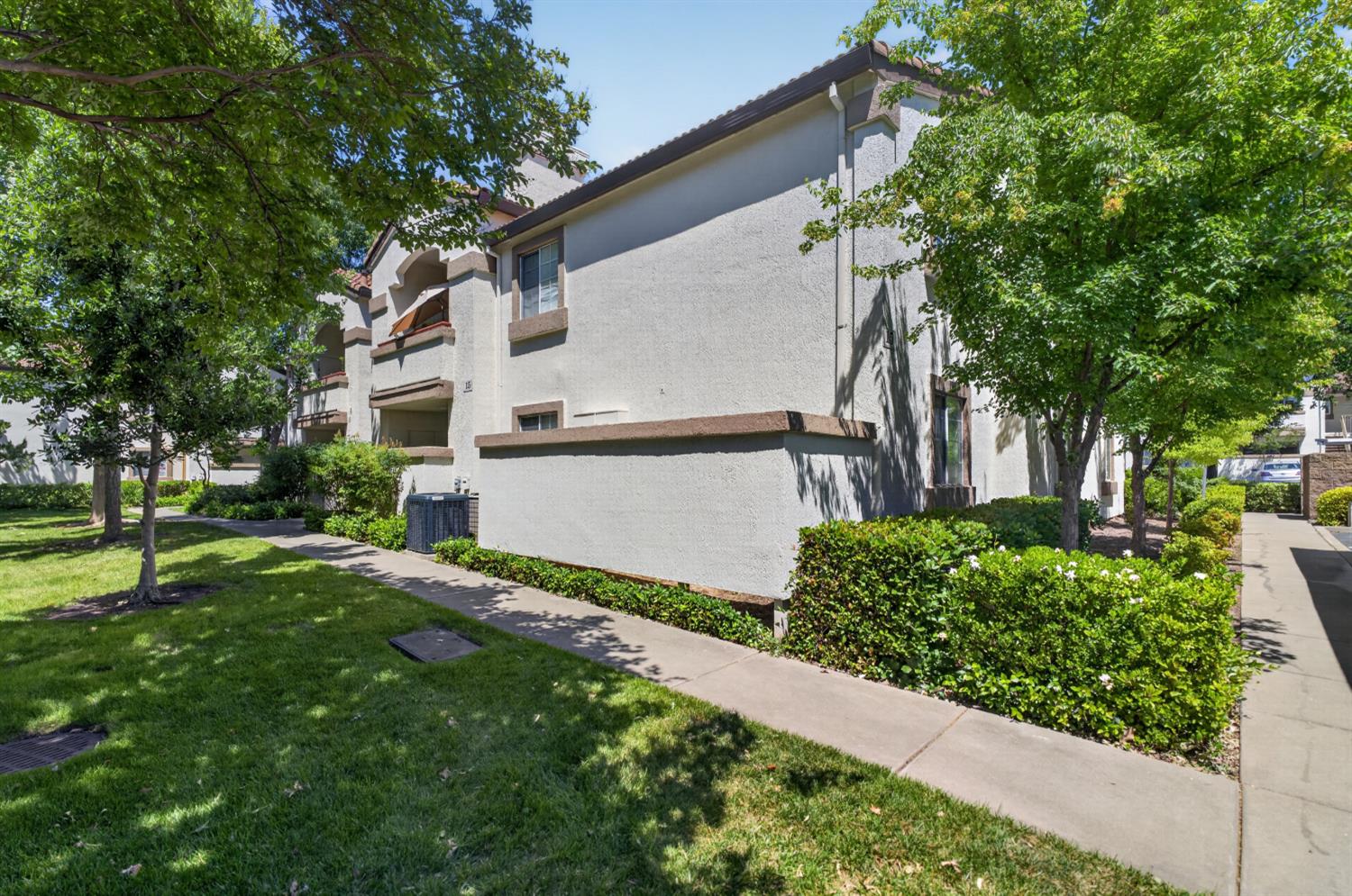 8020 Walerga Road, Unit 1140 Antelope, CA 95843 - Photo 4 of 37 a view of a white house with a big yard and large tree