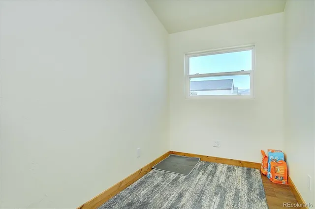 a view of room with window and wooden floor