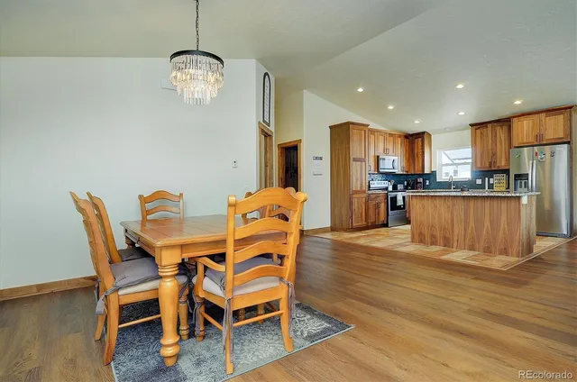 a dining room with furniture and wooden floor