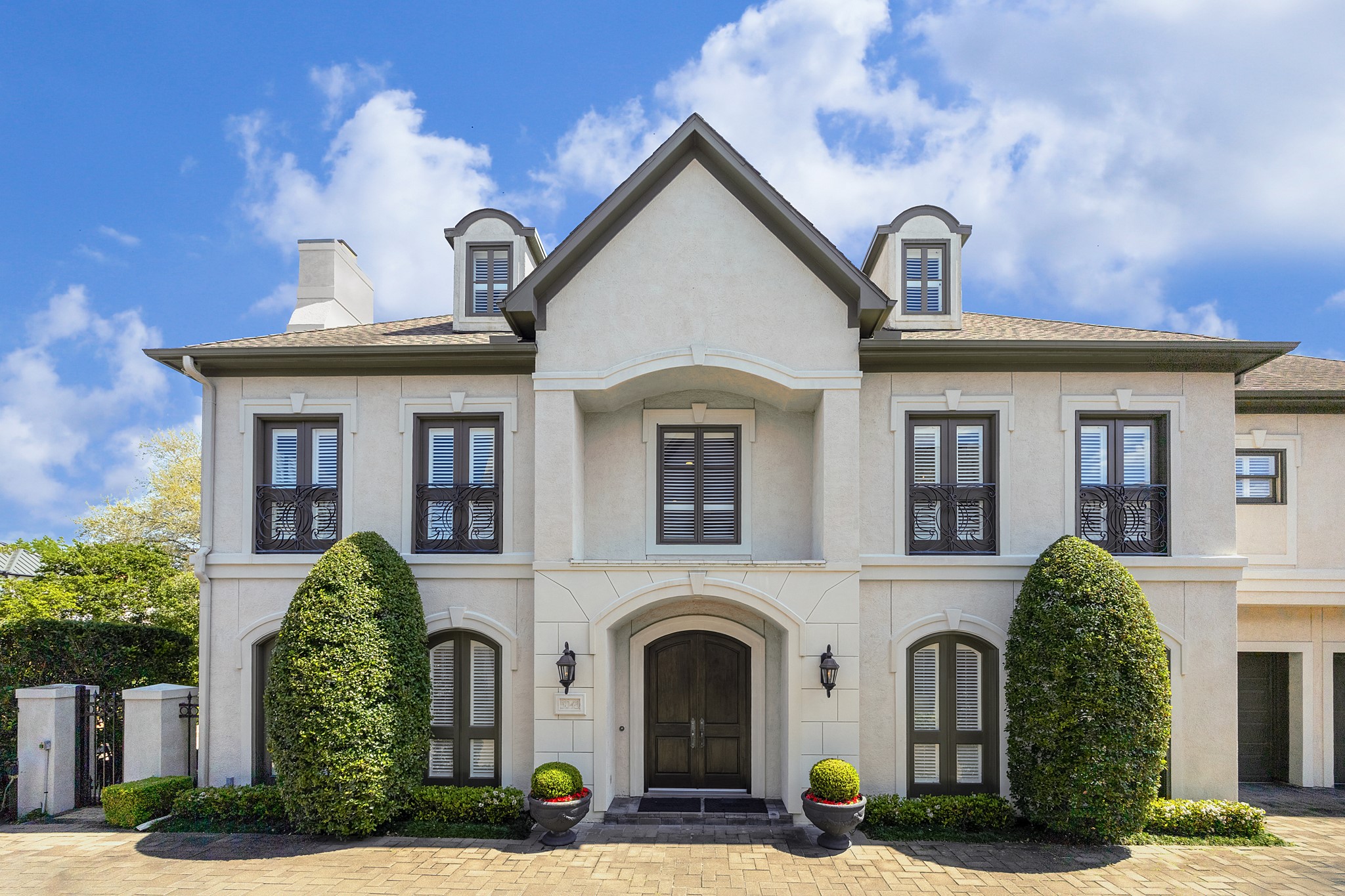 a view of a white house with large windows