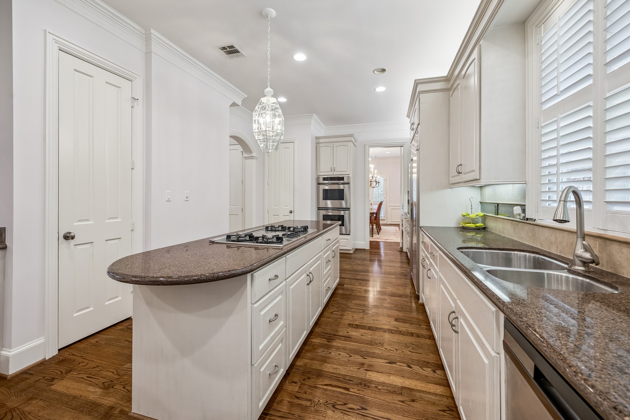 5043 Tangle Lane Houston, TX 77056 - Photo 13 of 50 a large kitchen with granite countertop a sink and a stove with wooden floor