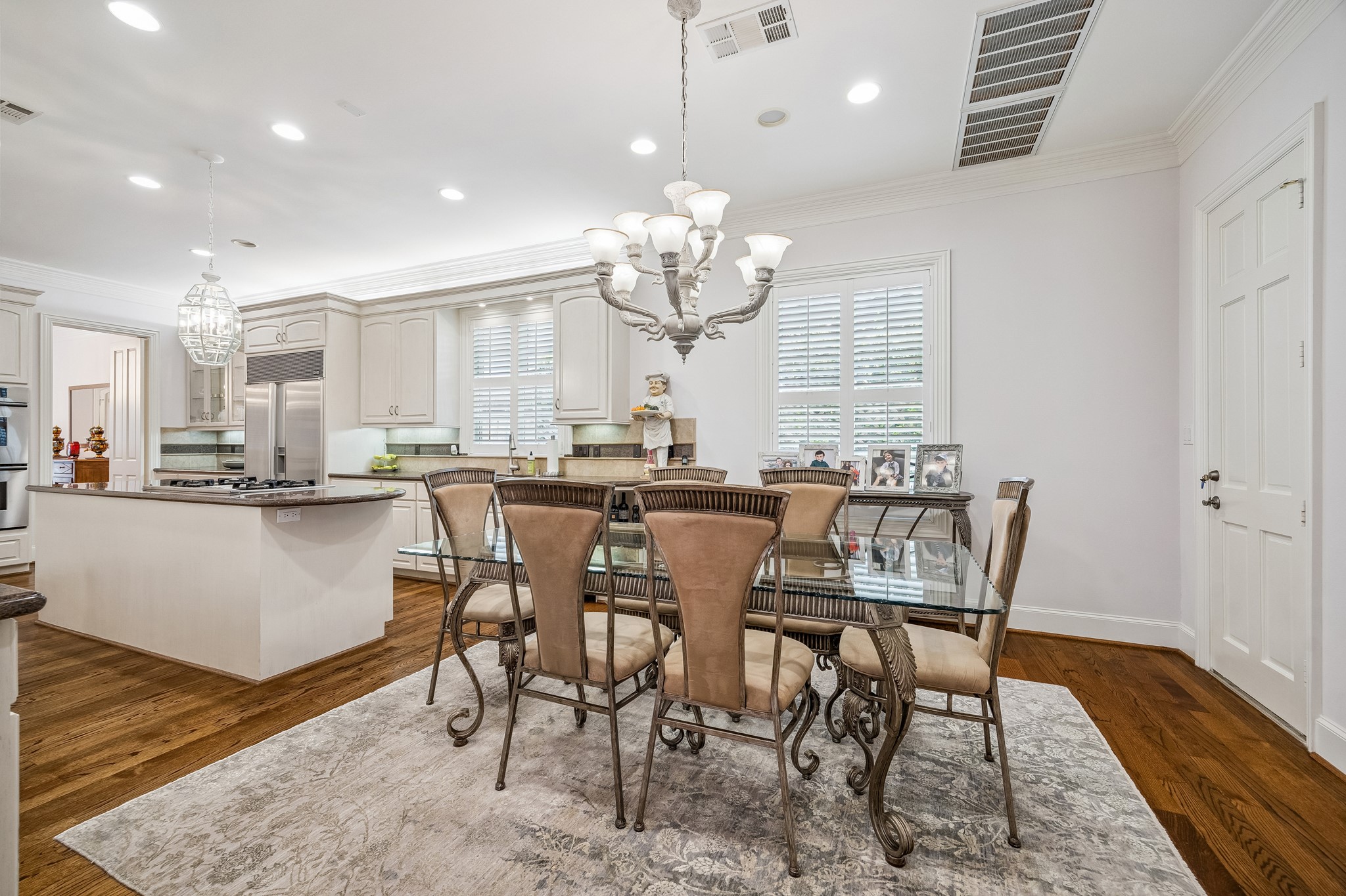 5043 Tangle Lane Houston, TX 77056 - Photo 14 of 50 a dining room filled chandelier and wooden floor