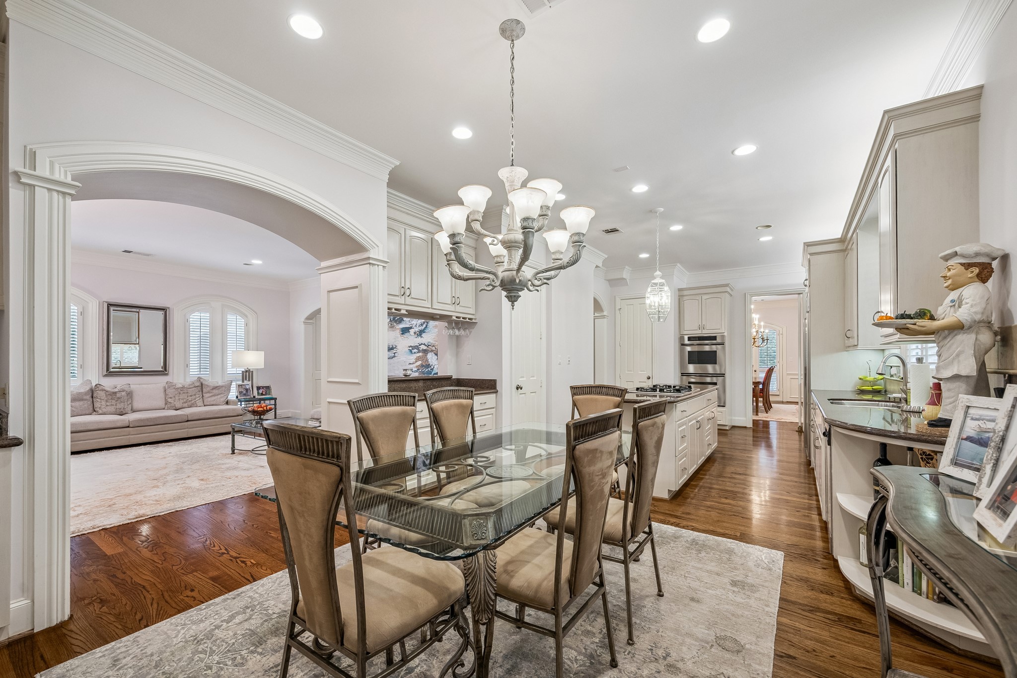 5043 Tangle Lane Houston, TX 77056 - Photo 15 of 50 a view of a dining room and livingroom with furniture wooden floor a chandelier