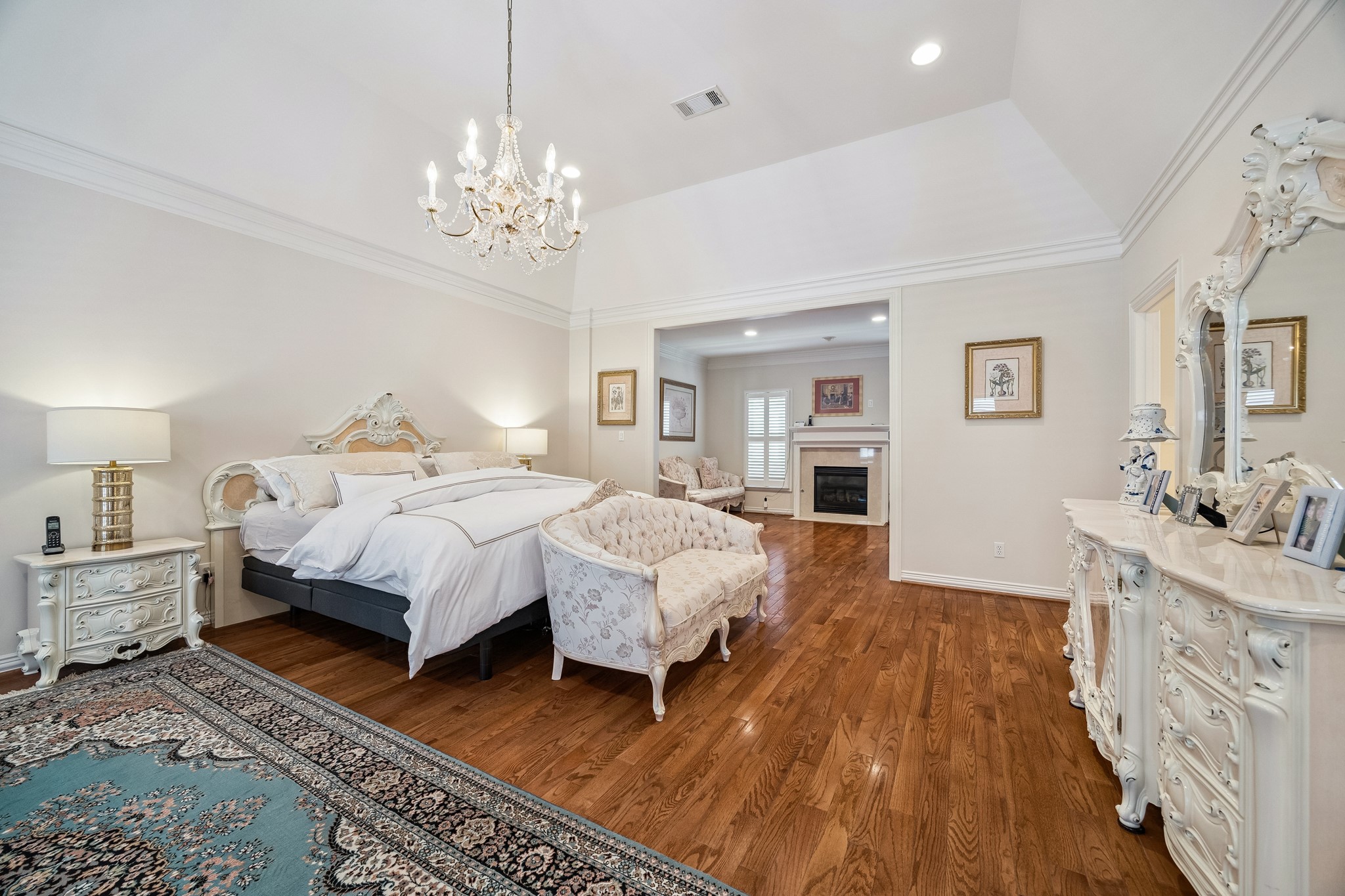 5043 Tangle Lane Houston, TX 77056 - Photo 21 of 50 a spacious bedroom with a bed and a chandelier