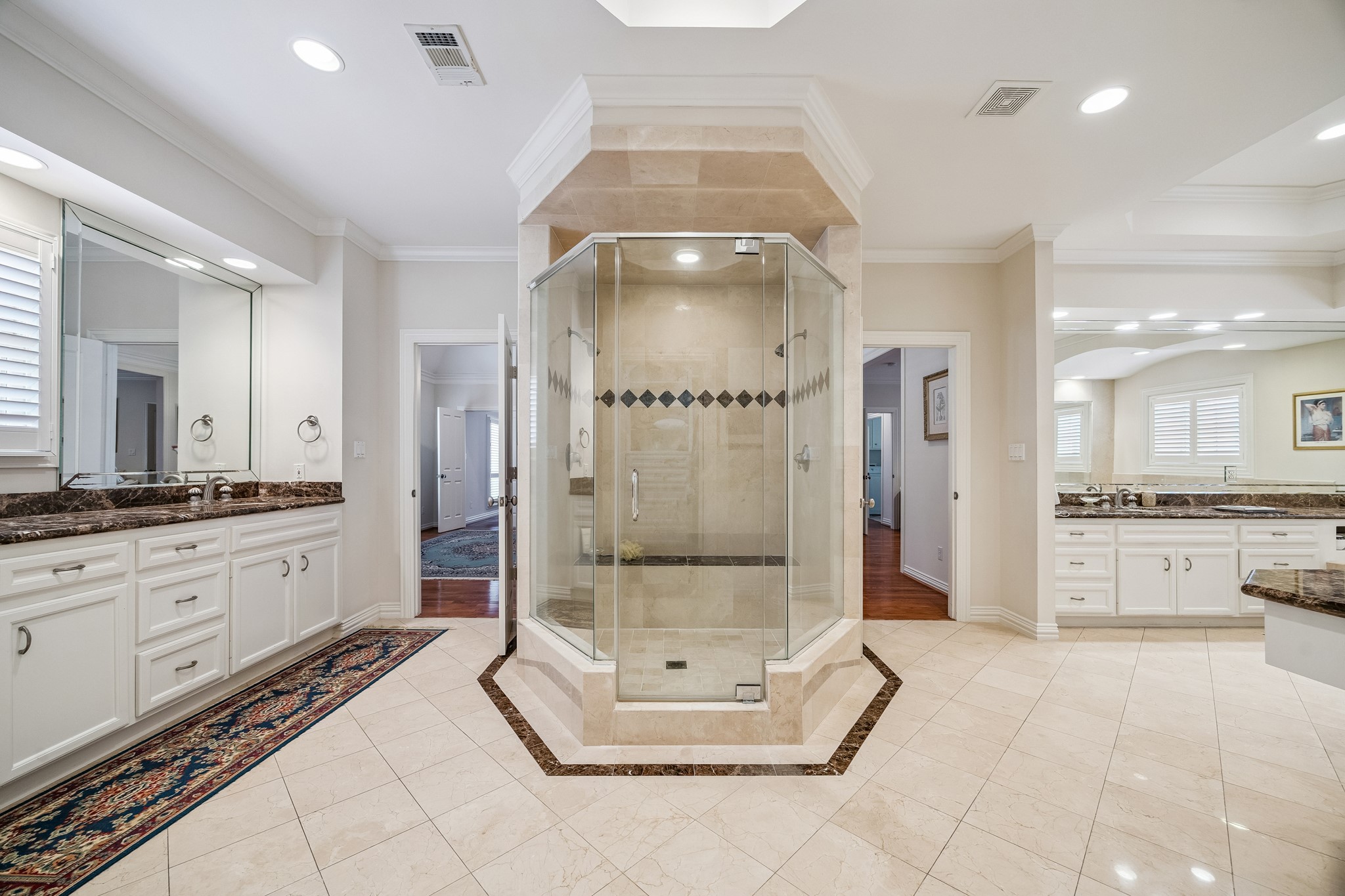 5043 Tangle Lane Houston, TX 77056 - Photo 23 of 50 a large bathroom with a glass door shower a sink and a mirror