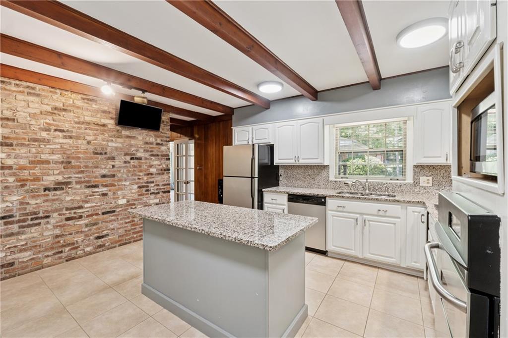 1387 Springdale Road Gainesville, GA 30501 - Photo 11 of 46 a kitchen with stainless steel appliances kitchen island granite countertop a stove sink and refrigerator