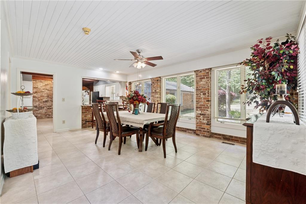 1387 Springdale Road Gainesville, GA 30501 - Photo 13 of 46 a view of a dining room with furniture and a potted plant