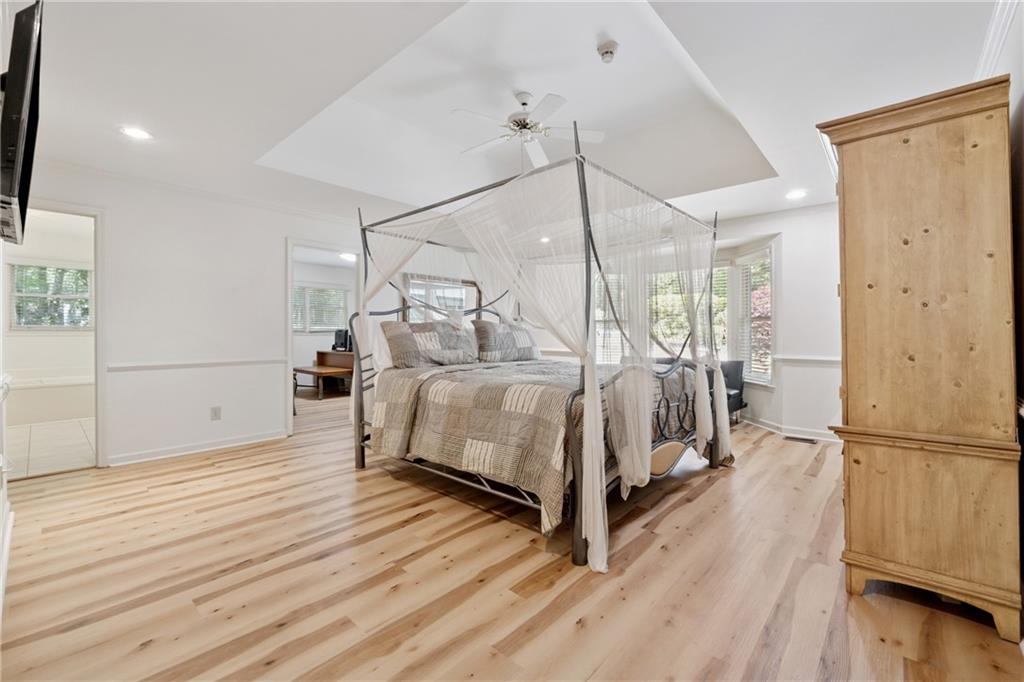 1387 Springdale Road Gainesville, GA 30501 - Photo 19 of 46 a bedroom with a bed and a chandelier