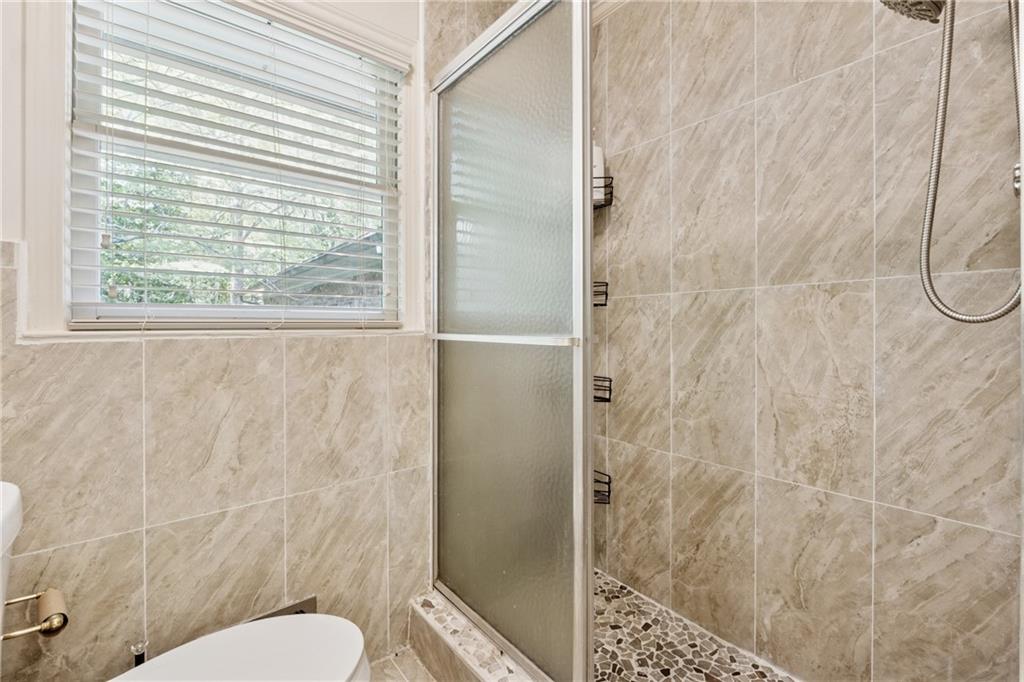 1387 Springdale Road Gainesville, GA 30501 - Photo 30 of 46 a bathroom with a toilet and a shower