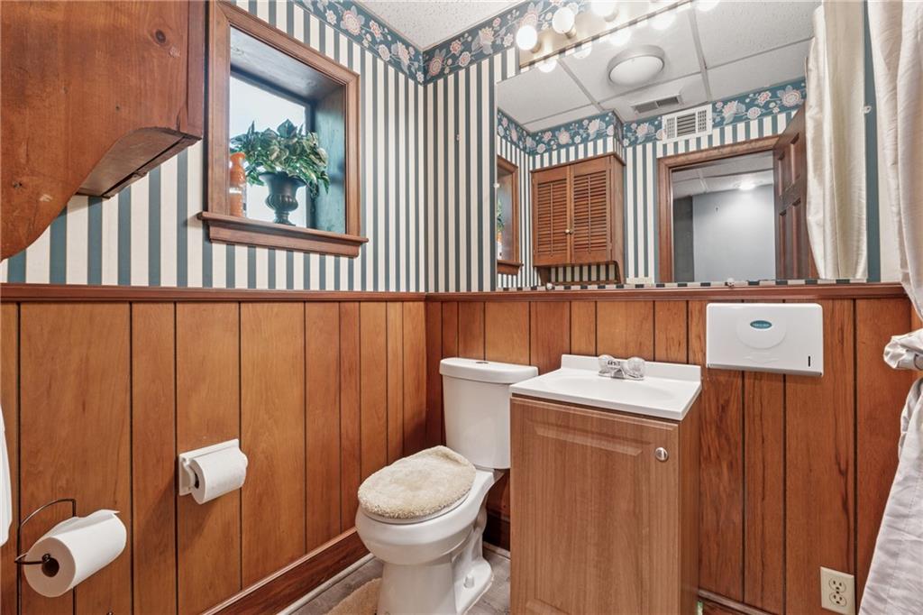 1387 Springdale Road Gainesville, GA 30501 - Photo 35 of 46 a bathroom with a toilet sink and mirror