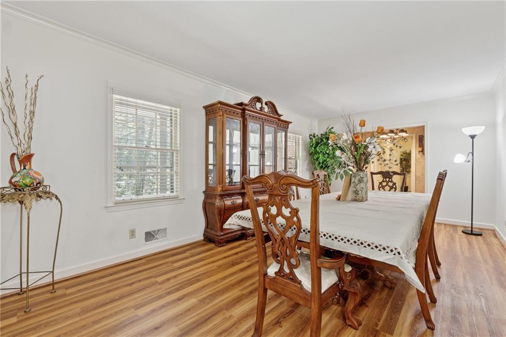 1387 Springdale Road Gainesville, GA 30501 - Photo 6 of 46 a view of a dining room with furniture and wooden floor