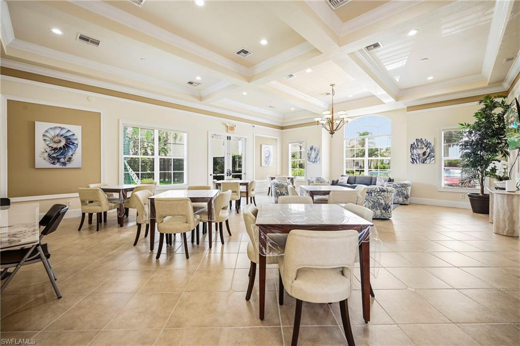 3916 Cherrybrook Loop Fort Myers, FL 33966 - Photo 28 of 31 Spacious gathering room featuring light-toned tile flooring, tray ceilings with recessed lighting, and expansive windows