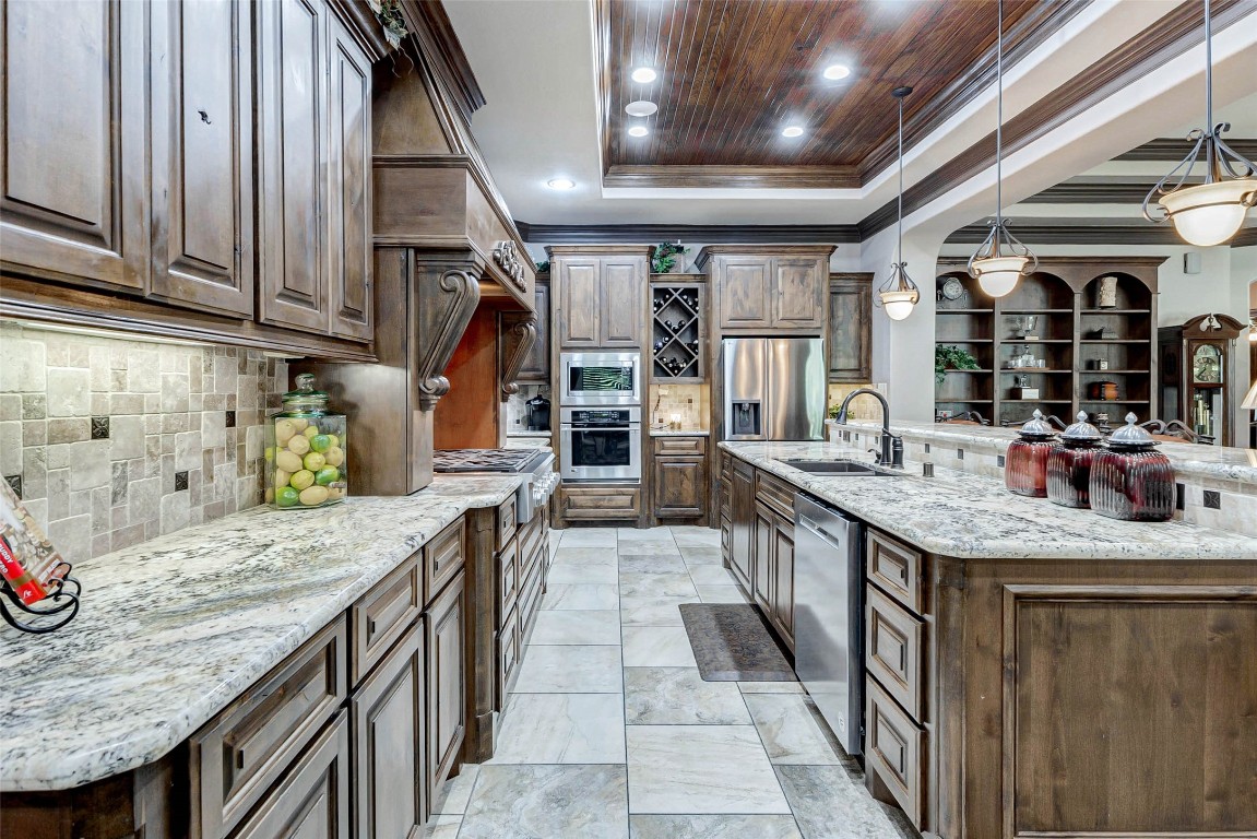 4315 Wickby Street Fulshear, TX 77441 - Photo 15 of 46 a kitchen with stainless steel appliances granite countertop a sink and cabinets