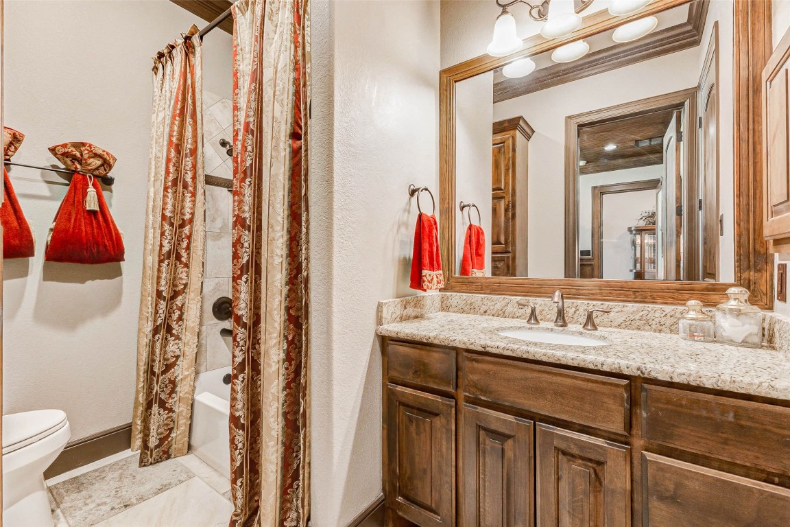 4315 Wickby Street Fulshear, TX 77441 - Photo 24 of 46 a bathroom with a granite countertop sink and a mirror