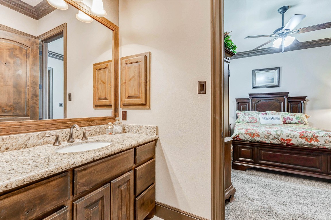 4315 Wickby Street Fulshear, TX 77441 - Photo 25 of 46 a bathroom with a granite countertop sink and a mirror