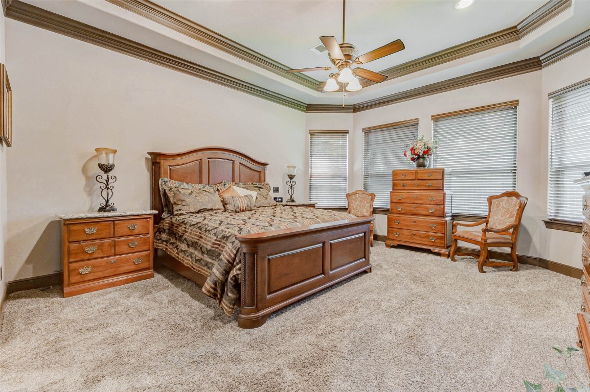 4315 Wickby Street Fulshear, TX 77441 - Photo 26 of 46 Spacious primary bedroom with trey ceiling and crown molding. Plenty or room for large furniture.