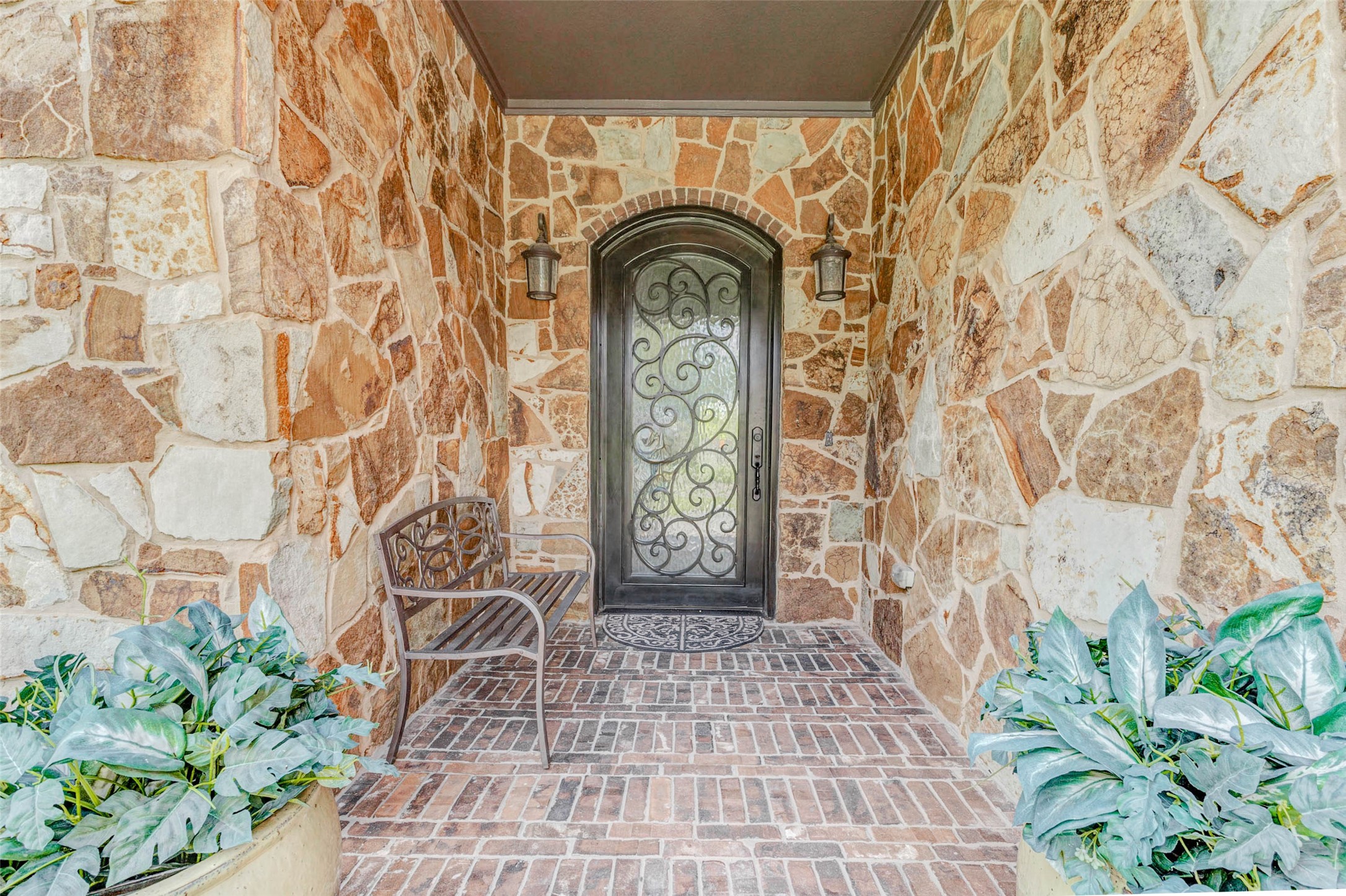 4315 Wickby Street Fulshear, TX 77441 - Photo 3 of 46 Charming entryway with rustic stone walls, brick flooring and a decorative wrought iron door.