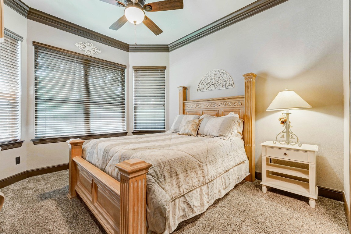 4315 Wickby Street Fulshear, TX 77441 - Photo 36 of 46 a bedroom with a bed and a chandelier