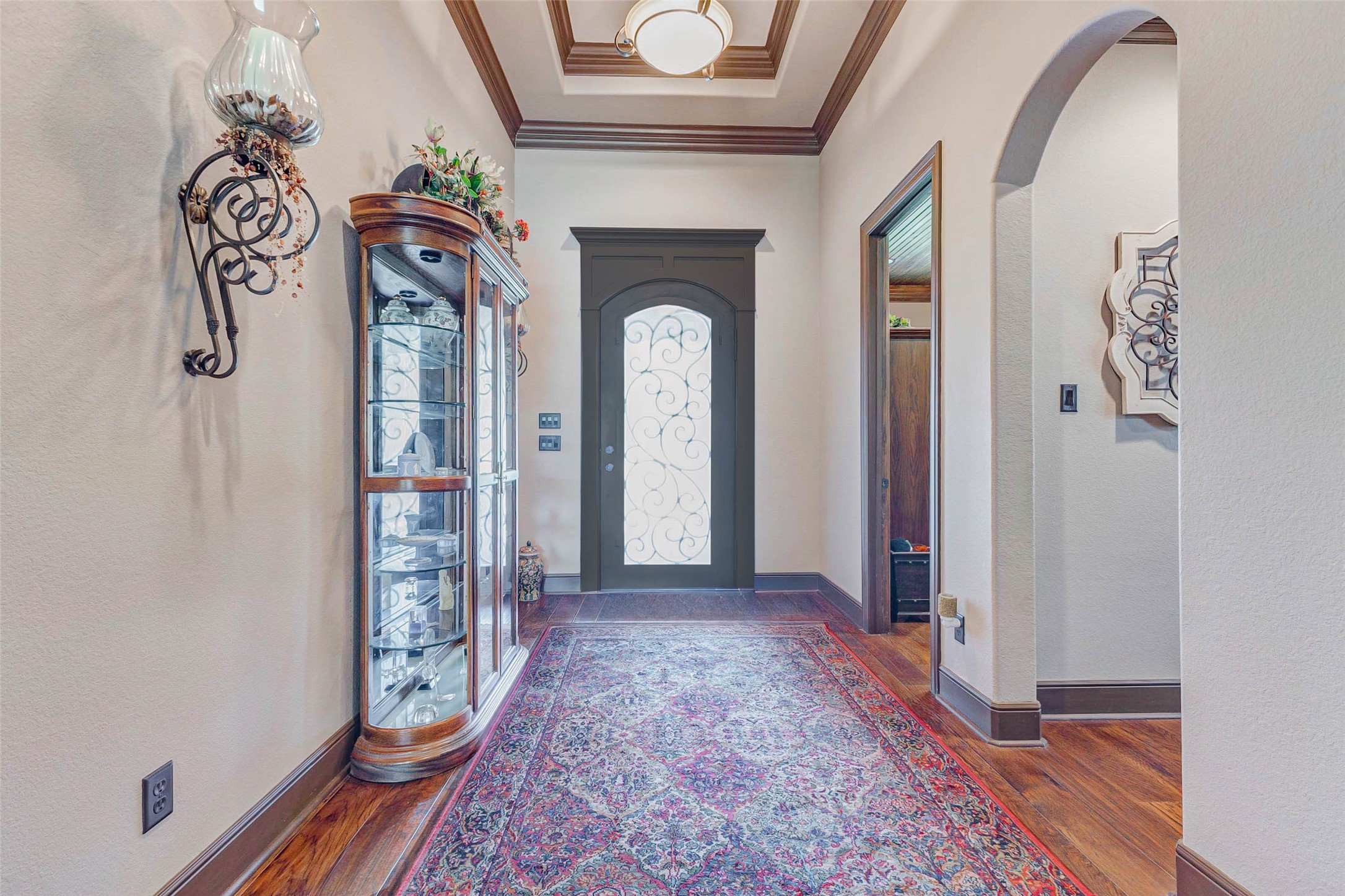 4315 Wickby Street Fulshear, TX 77441 - Photo 4 of 46 This inviting entryway features a decorative glass front door, elegant crown molding with arched entry to one of the secondary bedrooms.