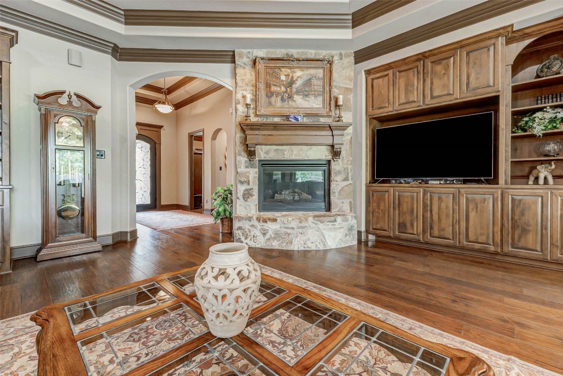 4315 Wickby Street Fulshear, TX 77441 - Photo 9 of 46 a living room with furniture a flat screen tv and a fireplace