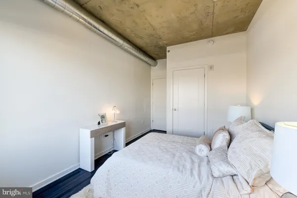 a bedroom with a bed and a chair