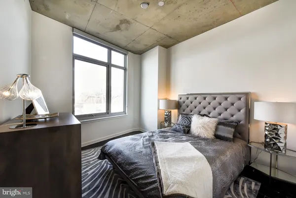 a bedroom with a bed and window