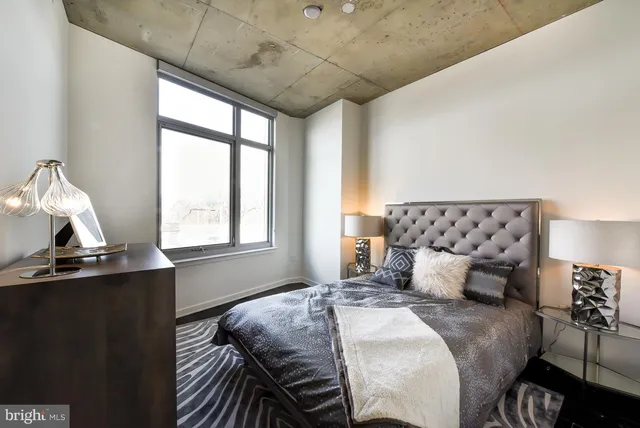 a bedroom with a bed and window