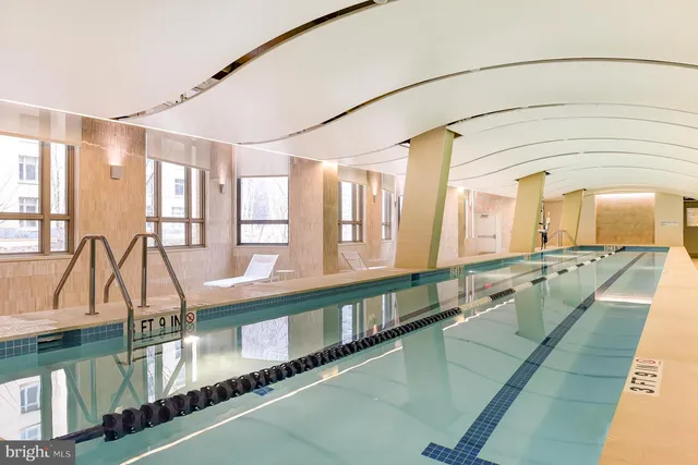 a view of house with swimming pool and furniture