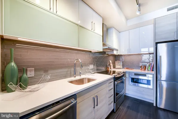 a kitchen with a sink appliances and cabinets