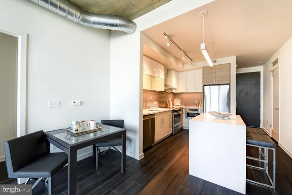 a kitchen with a refrigerator and a table