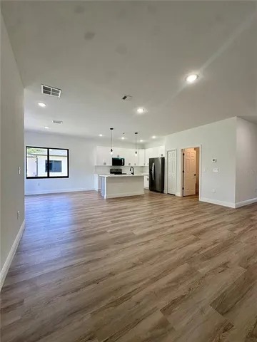 a view of a room with wooden floor
