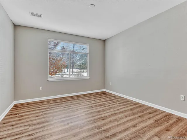 a bathroom with a granite countertop sink a mirror and a shower