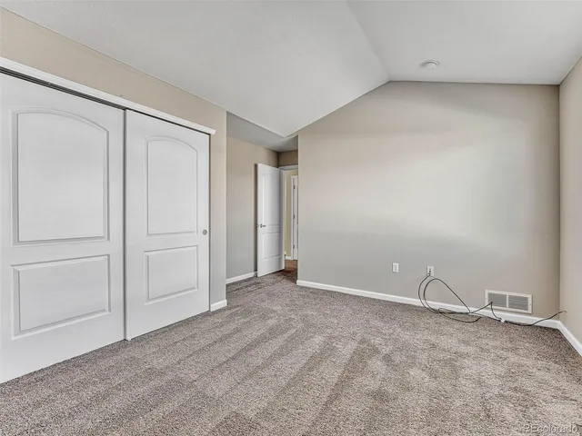 a bathroom with a granite countertop sink a toilet and a mirror
