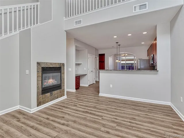 a view of a kitchen with an empty space and a fireplace