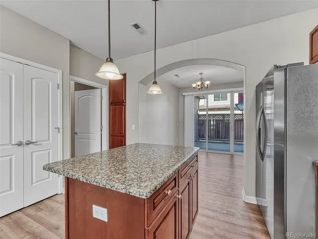 a kitchen with stainless steel appliances granite countertop stove top oven and refrigerator