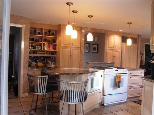 101 Hampton Road Sharon, MA 02067 - Photo 7 of 29 a kitchen with stainless steel appliances granite countertop a stove a chimney a sink and a refrigerator