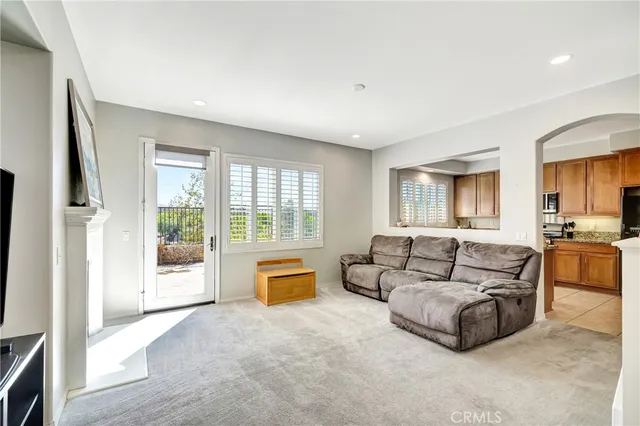 a living room with a fireplace and a painting on the wall
