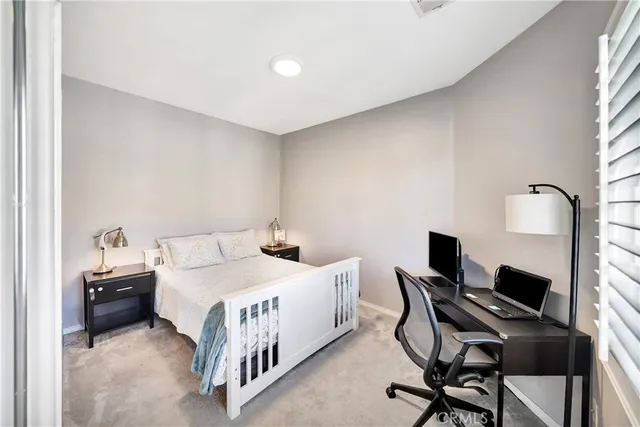 a bathroom with a granite countertop double vanity sink a mirror and a bathtub